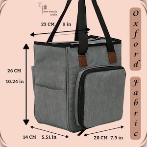 May include: Gray fabric tote bag with black handles and a zippered pocket on the side. The bag measures 9 inches wide, 10.24 inches tall, and 7.9 inches deep. The bag is labeled "Oxford Fabric".
