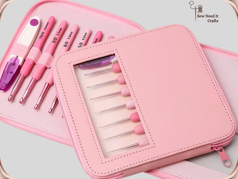 May include: A pink crochet hook set in a matching case. The case is open, revealing several crochet hooks with pink handles and silver hooks. The case has a clear window to display the hooks. The set includes a variety of hook sizes.