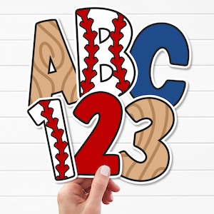 May include: A collection of die-cut letters and numbers including a tan wood-grain letter A, a white letter B with red baseball stitching, a solid blue letter C, a white number 1 with red baseball stitching, a solid red number 2, and a tan wood-grain number 3.