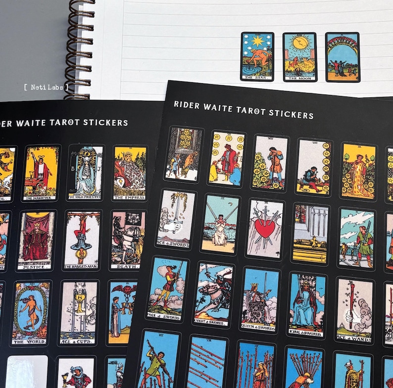 May include: A set of Rider Waite Tarot stickers featuring black and white illustrations of the major arcana cards. The stickers are printed on a black background with white text that reads "Rider Waite Tarot Stickers".