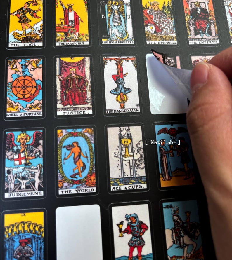 May include: A set of tarot cards with colorful illustrations and black borders. The cards are arranged in a grid pattern on a black background. The cards are labeled with their names, such as "The Fool", "The Magician", "The High Priestess", "The Empress", "The Emperor", "Wheel of Fortune", "Justice", "The Hanged Man", "Judgement", "The World", and "Ace of Cups".