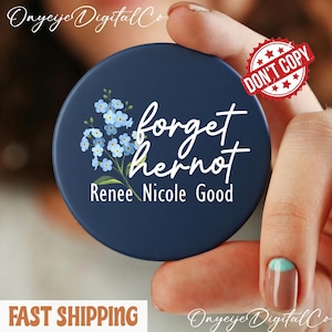 May include: A navy blue round phone grip with the words "forget her not" in white script, along with the name "Renee Nicole Good" and a floral design. The words "DON'T COPY" are stamped on the top right.