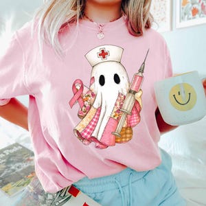 Ghost Nurse Breast Cancer Shirt, Nurse Halloween Shirt, Breast Cancer Awareness Shirt, Halloween Breast Cancer Shirt In October We Wear Pink
