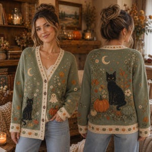 May include: A sage green V-neck button-down cardigan featuring a knit pattern of black cats, orange pumpkins, white ghosts, crescent moons, and floral motifs. The design is displayed on both the front and back of the garment.