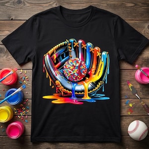 May include: Black t-shirt featuring a colorful baseball glove holding a baseball. The baseball and glove have a vibrant, dripping paint effect in shades of red, orange, yellow, blue, and green. The design is artistic and eye-catching.