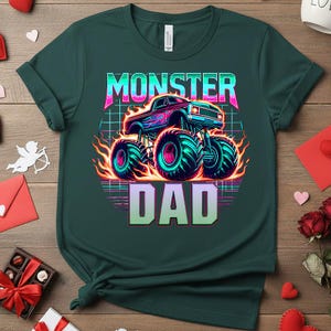 Peut inclure: T-shirt vert fonc&eacute; avec un motif de monster truck color&eacute; et le texte "MONSTER DAD". Le design comprend des flammes et un fond quadrill&eacute;, parfait pour la f&ecirc;te des p&egrave;res. Le t-shirt est en mati&egrave;re douce.