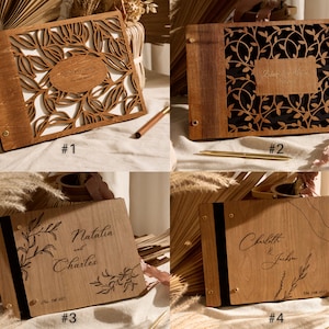 May include: Four wooden guest books with different designs. The first book has a cut-out design of leaves and the text "Wedding Day" in a circle. The second book has a black background with a cut-out design of leaves and the text "Blake & Megan". The third book has a design of leaves and the text "Natalia and Charles" with the date "Oct 2021". The fourth book has a design of leaves and the text "Charlotte & Jackson" with the date "Oct 2021".