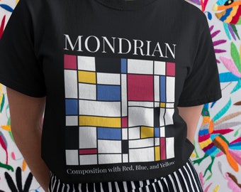 May include: Black t-shirt featuring a Mondrian-inspired design with red, blue, yellow, and white geometric shapes. The shirt includes the text "MONDRIAN" and "Composition with Red, Blue, and Yellow". The background is a colorful floral embroidery.