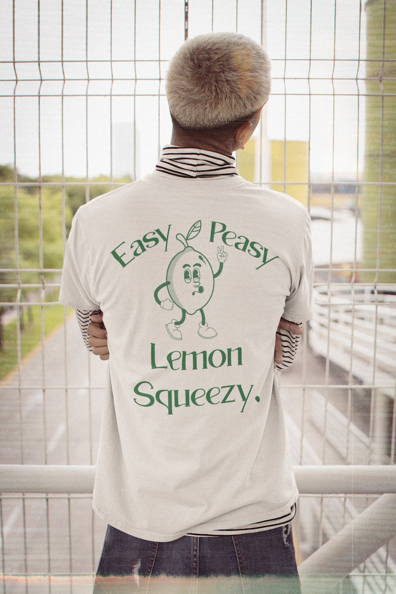 Add a touch of sunshine to your day with this Easy Peasy Lemon Squeezy t-shirt. The playful lemon graphic and lighthearted message capture the essence of summery fun. A perfect addition for any casual outfit, Salthree Shirts