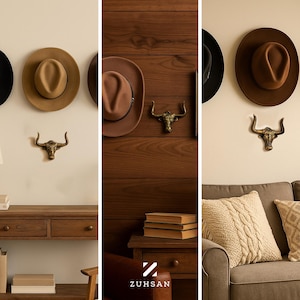 May include: A collection of wide-brimmed felt hats in shades of tan and brown, paired with metallic bull head wall hooks. The display features a logo with the text ZUHSAN, showcasing a coordinated arrangement of headwear and decorative hardware.