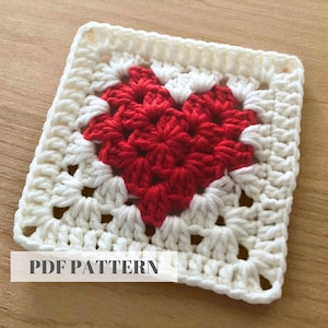 May include: A white crochet square with a red heart in the centre. The text "PDF PATTERN" is printed below the square.
