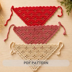 May include: Three handmade crochet bandanas in red, mauve, and cream. Each bandana features a scalloped edge and a floral pattern. The bandanas have long ties for securing around the neck. The text "PDF PATTERN" is visible on the bottom bandana.