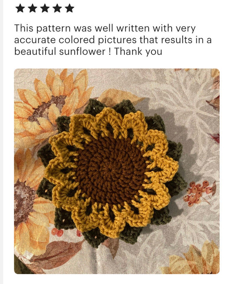 May include: Crocheted sunflower coaster in shades of brown, yellow, and green. The coaster is made with a textured yarn and has a raised center.