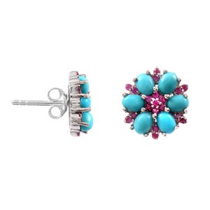 May include: A pair of flower-shaped stud earrings. Each earring features six oval turquoise stones arranged around a cluster of small, round, pink gemstones. The earrings have a silver-colored metal setting and a post back.