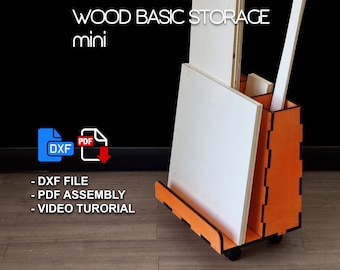 May include: A mini wood storage unit with a bright orange finish and black accents. The unit has a shelf for storing flat items and a compartment for storing long items. The unit is on wheels and has a label that says "WOOD BASIC STORAGE mini".
