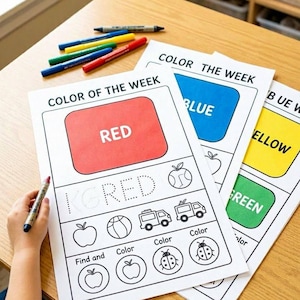 May include: Educational activity sheets titled Color of the Week and Color the Week with red, blue, yellow, and green color blocks. The sheets feature tracing text, black and white line art of objects like apples, balls, and trucks, and markers.