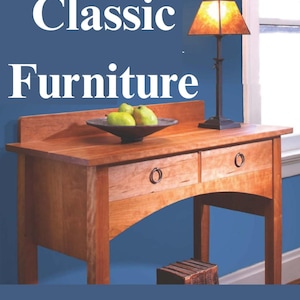 May include: A wooden desk with two drawers and a dark metal ring pull. A lamp with a square shade sits on the desk. The text "Classic Furniture" is at the top, and "20 Elegant Shaker And Arts & Crafts Projects" is at the bottom.