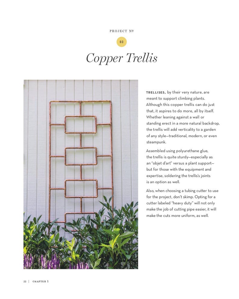 May include: A copper trellis with a rectangular design, suitable for climbing plants. The trellis is made of copper tubing and is mounted against a white wall. The text "Copper Trellis" is at the top of the image.
