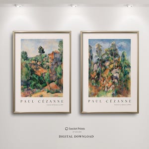 May include: Two framed art prints featuring landscape paintings by Paul Cézanne. The artwork showcases vibrant colors, with green trees, blue skies, and earthy tones. The prints are in gold frames and are displayed on a white wall.