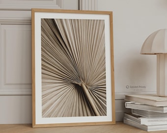 May include: A framed wall art print featuring a close-up of a dried palm leaf with radiating linear textures in shades of beige and tan. The print is housed in a light wood frame and includes the text IonArt Prints by Lora Bibo in the corner.