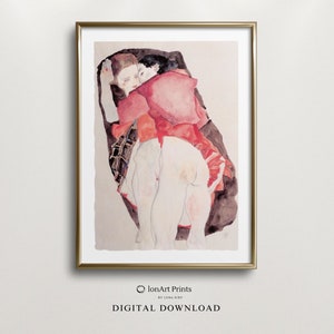 Puede incluir: Una pintura de acuarela de dos personas abrazándose. La mujer lleva un vestido rojo y el hombre lleva una camisa negra. La pintura está en un marco dorado.