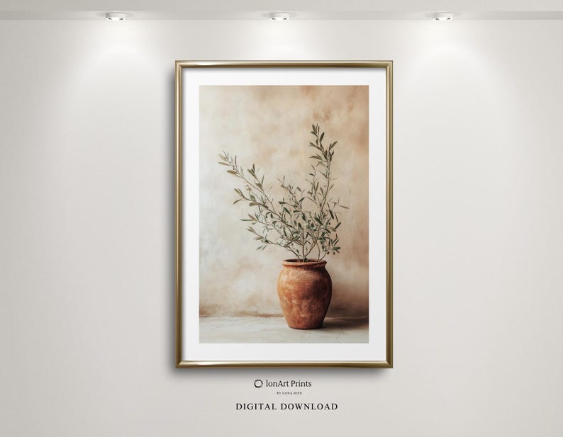 May include: A framed wall art print featuring a terracotta pot containing a green olive branch. The print is labeled IonArt Prints and Digital Download. The artwork displays a neutral, earthy color palette with a textured, mottled background.