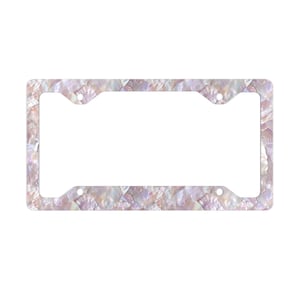 May include: A white license plate frame with a pink and white iridescent shell pattern.