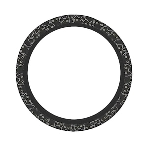 May include: A black steering wheel cover with a repeating pattern of white cat faces. The cover is circular and designed to fit around a steering wheel. The cat faces are simple line drawings, creating a playful and stylish design.