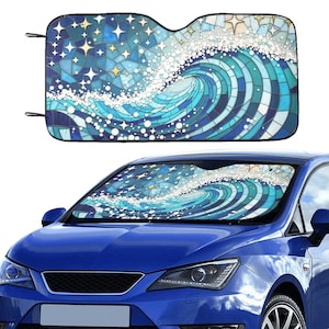 May include: A blue car sunshade with a mosaic wave design. The sunshade features a swirling wave pattern in shades of blue and white, with star accents. The sunshade is shown installed on a blue car.