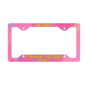 May include: Pink license plate frame with a yellow and blue pattern and the text "Oh East" and "I thought you said Weast".