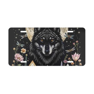 May include: Black wolf with glowing yellow eyes, surrounded by a full moon, flowers, and dragonflies on a dark blue background.