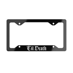 May include: Black license plate frame with the text "Til Death" in a gothic font. The frame has a rectangular shape with rounded corners and mounting holes.