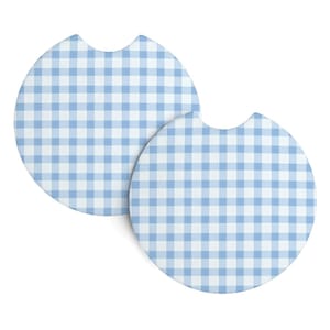 May include: Two round car coasters with a light blue and white gingham pattern. Each coaster has a curved notch on one side. The coasters are designed to fit in a car's cup holder.