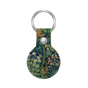 May include: A round keychain with a silver ring and a decorative design. The design features a tree with green leaves, orange flowers, and a flying bird against a dark blue background. The keychain is a stylish accessory.