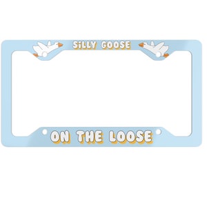 May include: A light blue license plate frame with white geese and the text "Silly Goose On The Loose" in yellow and white.