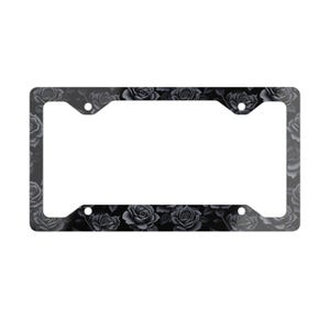 May include: Black and white license plate frame with a floral pattern of roses.