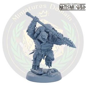 May include: A grey, detailed miniature figurine of a turtle warrior holding a spear. The figurine is standing on a round base with a textured surface.