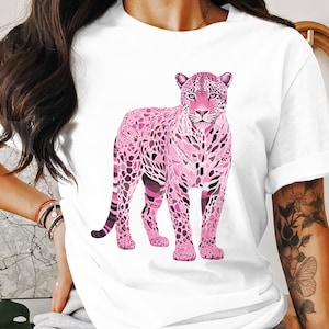 May include: A white t-shirt featuring a pink and purple graphic of a leopard. The leopard is standing on all fours and has a detailed pattern.