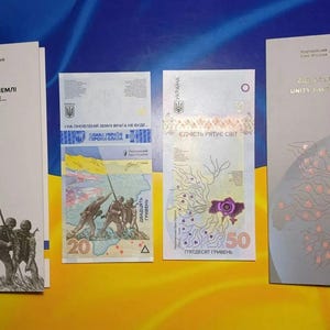 Ukrainian iconic banknotes - bestsellers , issued during the war. REMEMBER! We Will Not Forgive! & Unity Saves The World Commemorative