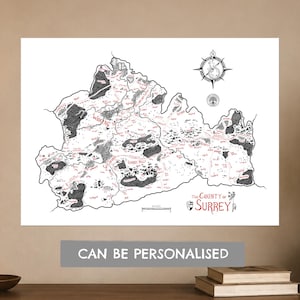 May include: A black and white illustrated map of the County of Surrey featuring red text labels, a compass rose, and a scale bar. The map includes detailed topographical markings, town names like Woking and Guildford, and a crest with the text The County of Surrey.