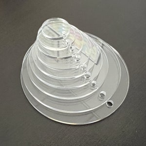 May include: A set of clear acrylic circles of varying sizes, stacked in a pyramid shape. The circles have a smooth, polished finish and are perfect for crafting projects.