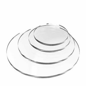 May include: Set of four clear acrylic round cake stands, stacked in decreasing size.