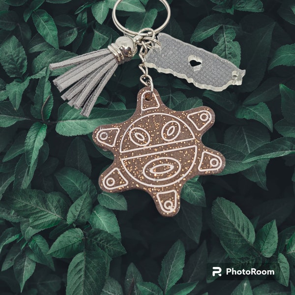 taino sun keychain with the island of Puerto Rico