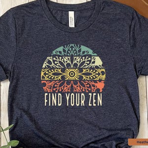 May include: A heather navy blue t-shirt with a colorful mandala design and the text "Find Your Zen".