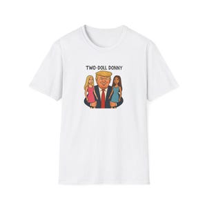 May include: White t-shirt with a cartoon image of Donald Trump with two women, and the text "TWO-DOLL DONNY".