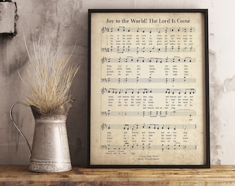 May include: A vintage-style print of the hymn "Joy to the World! The Lord Is Come" with sheet music and lyrics. The print is framed in a black frame and has a cream background.
