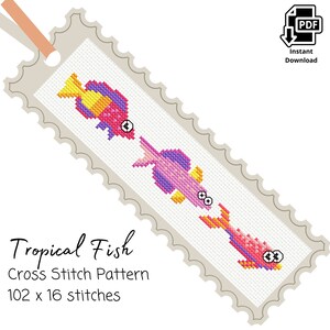 May include: A cross stitch pattern for a bookmark featuring three tropical fish. The fish are pink, yellow, and purple with black eyes. The pattern is 102 stitches wide and 16 stitches tall.  The text "Tropical Fish Cross Stitch Pattern 102 x 16 stitches" is printed below the fish.