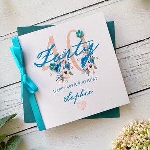 40er Jahre Geburtstagskarte für Sie. Hübsche handgemachte personalisierte Geburtstagskarte. Türkis und Weiß mit Schleife, Gems und Papierblumen.