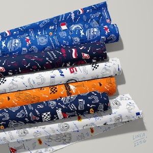 May include: Six rolls of fabric featuring Formula 1 themed patterns in blue, dark blue, white, and orange. The prints include race cars, checkered flags, trophies, helmets, and text such as "Simply Lovely," "World Champion," and "Unleash the Lion."