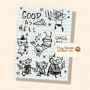 May include: A black and white cartoon illustration on lined paper. It features cat-like characters, pizza slices, and the text "GOOD AS HELL" and "GREGG RULZ". A sticker with the text "Tiny Garden Sticker Co." is also present.